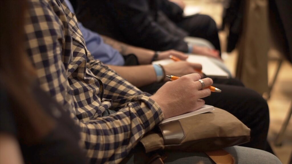 Close-up of Hands holding pens at the conference. Stock. Training, Business, Presentation